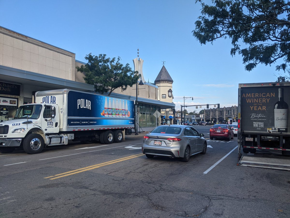 FigCop's tweet image. I spy with my little eye two illegally parked behemoths in #CoolidgeCorner #Brookline. @BrooklineMAPD how much is the fine for parking in a bus stop, parking in a bike lane, parking in a car lane, blocking view of a pedestrian crossing? @BlineTransport