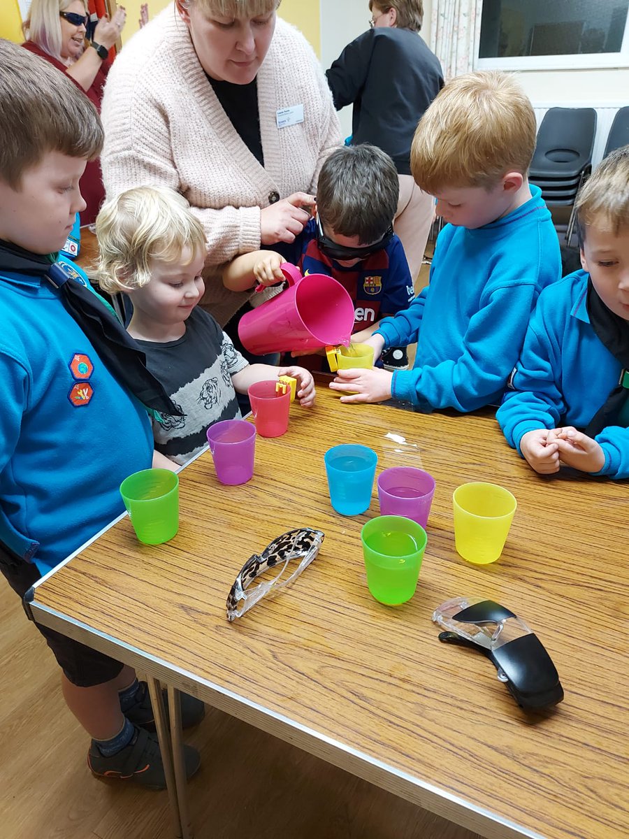 a young boy wearing sim specs and pouring a drink using a liquid level indicator