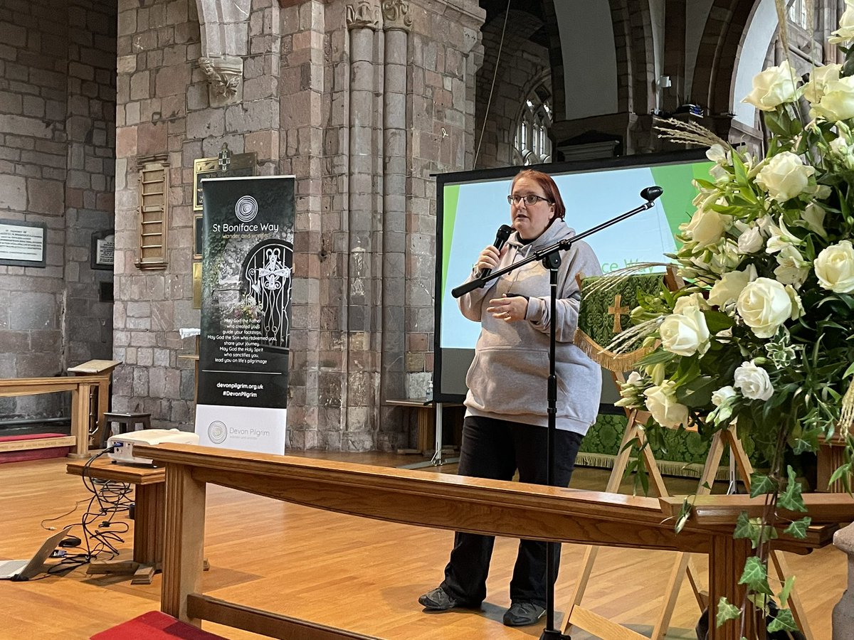 PilgrimageDevon's tweet photo. Sam from the @GtRCDevon team welcomes people to Crediton Parish church at the start of a day of events to mark the launch of the St Boniface Way. #devonpilgrim #Boniface #pilgrimage @CofEDevon https://t.co/aNjy3ga2AL