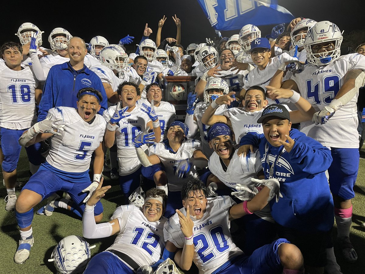 Flashes celebrate with the Leather Helmet after their — checks notes — 57-7 win at Santa Paula