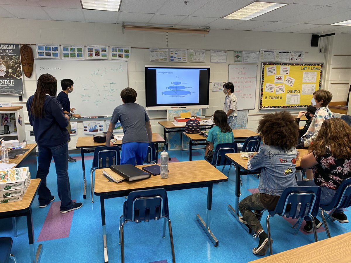 Gifted students in World Geo class work with Mr. Helms and RTG Ms. Washington to find a solution to a hard latitude and longitude extension problem during lunch.  The solution, as developed and shown by a student, turned out to require geometry and trigonometry. @APSGifted