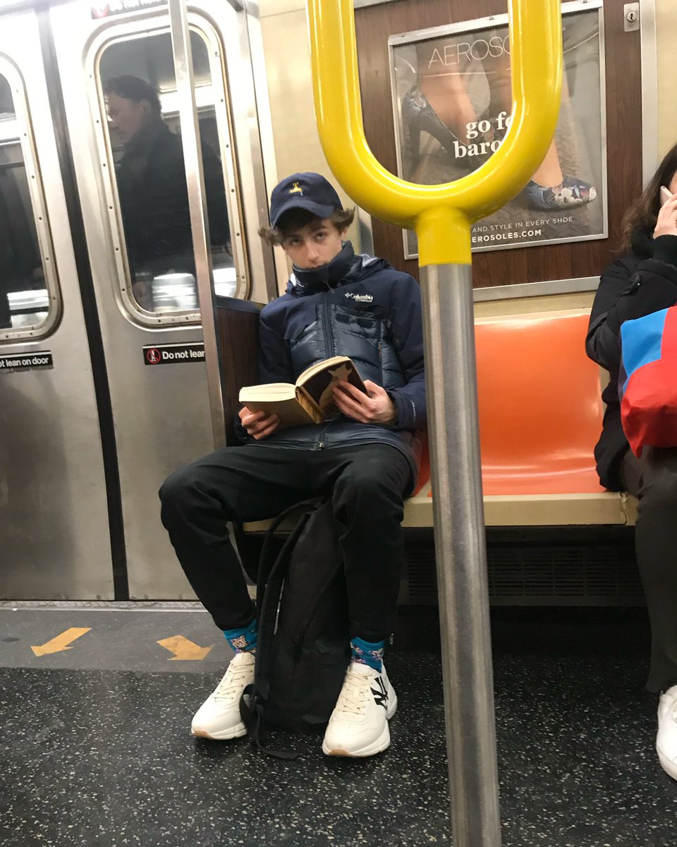 In honor of the new Dune film, here’s a photo I took in 2018 sitting across from Timothée Chalamet reading dune on the F Train