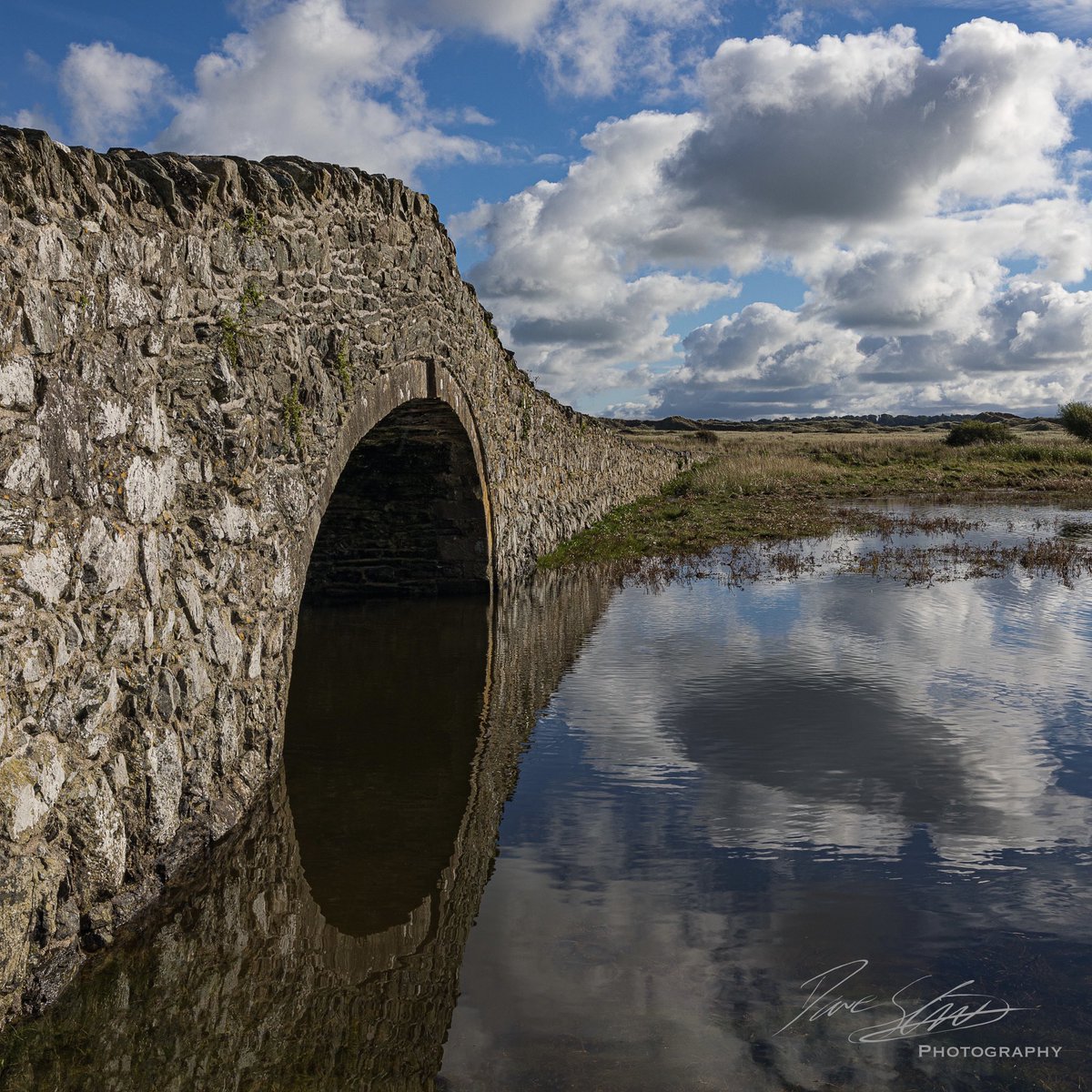 Reflection. A view of the bridge at Aberffraw overlooking the estuary and dunes. #reflections <a href="/VisitAnglesey/">Visit Anglesey</a> <a href="/wextweets/">Wex Photo Video</a> <a href="/tourism_wales/">Tourism Wales</a> <a href="/davyhulmecc/">Davyhulme CameraClub</a> <a href="/CanonUKandIE/">Canon UK and Ireland</a> <a href="/SigmaImagingUK/">SIGMA UK</a>