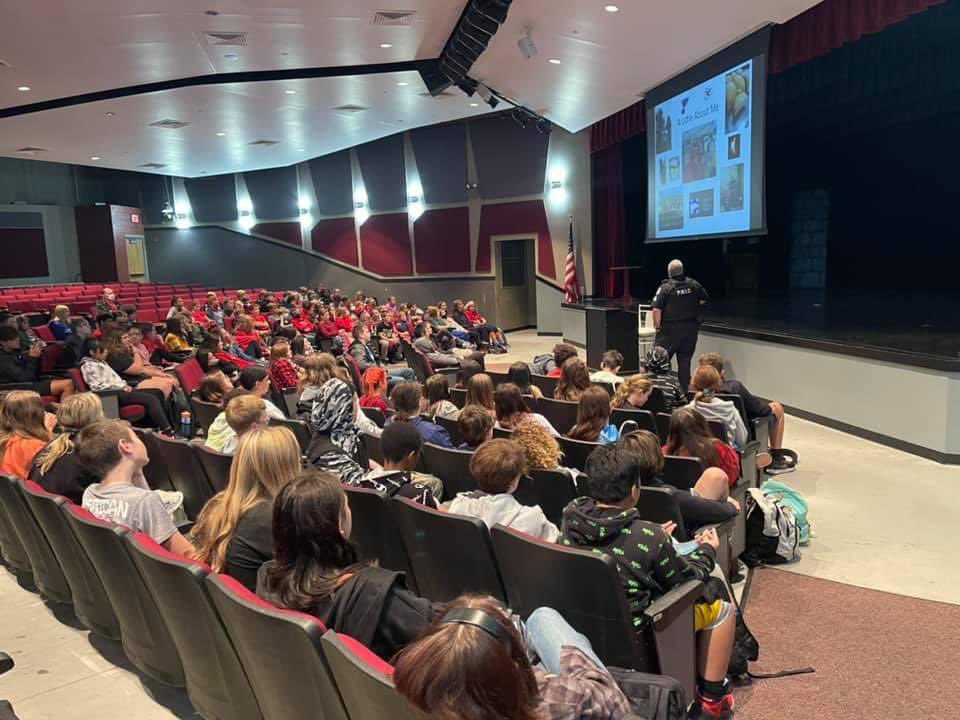 MrsCurran_CCMS's tweet photo. CCMS kicked off Red Ribbon Week by wearing red and getting a visit from Officer Jensen from the Plattsburg Police Department. He talked to our students about the dangers of drugs and vaping. The students also signed a pledge to remain drug free. @CCMSTigers #RedRibbonWeek https://t.co/uPExvFWRCL