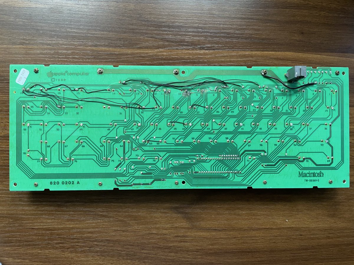 Cracked Mac plus keyboard fixed up with a combo of sanding traces to the copper to solder across the crack and adding jumper wires where the crack intersected multiple times or the traces were too small. A super fun fix!