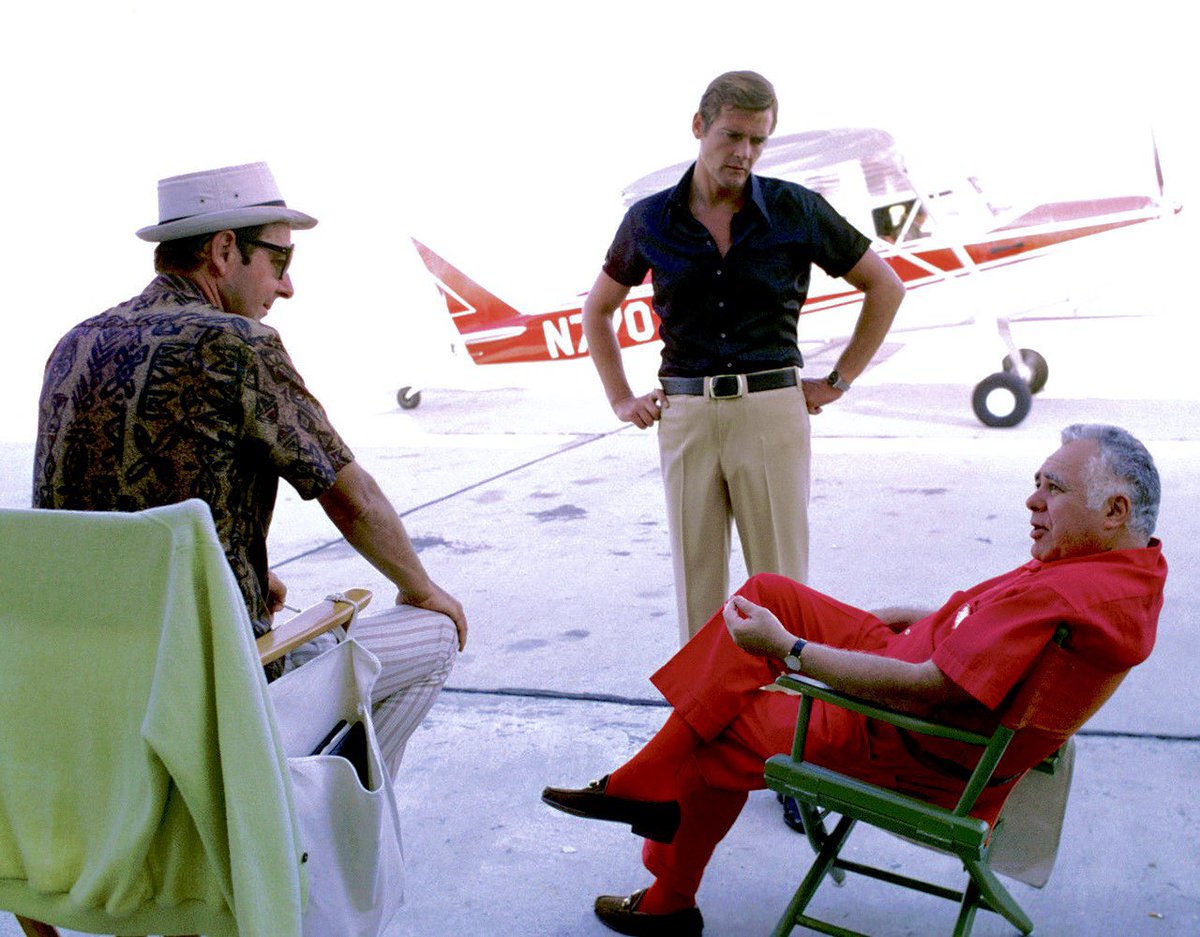 #HarrySaltzman #BOTD photographed here in October 1972 with film director #GuyHamilton and #RogerMoore in his first outing as secret agent 007 on location at #Lakefront Airport in #NewOrleans during a break in filming on the #JamesBond film “LIVE AND LET DIE” (1973)