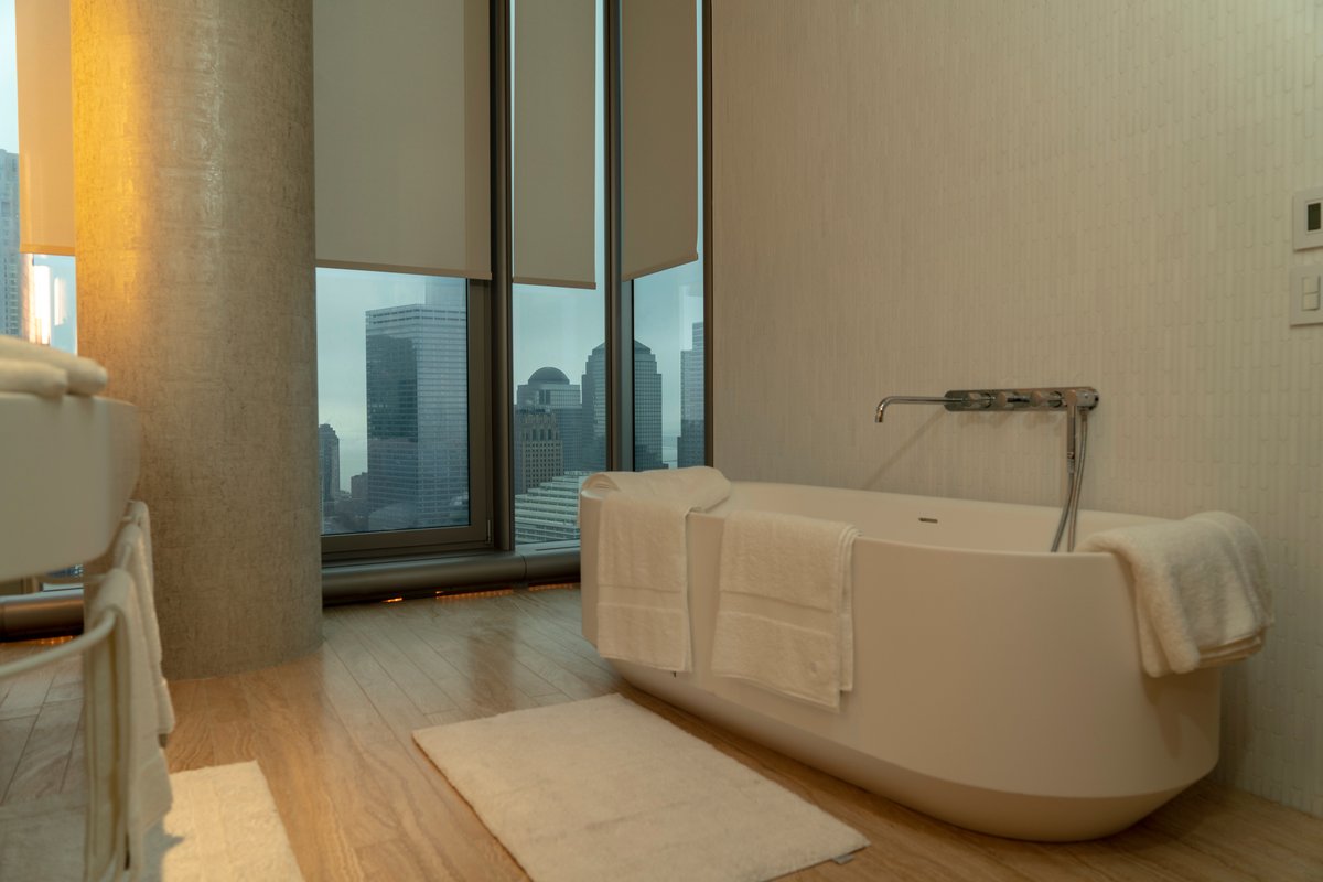 How beautiful is this New York penthouse master bathroom?  

Above this double sink, we installed hidden lights and with breath-taking views from the bathtub across the city, we also installed Lutron automated blinds that open and close using a phone, tablet or remote control.