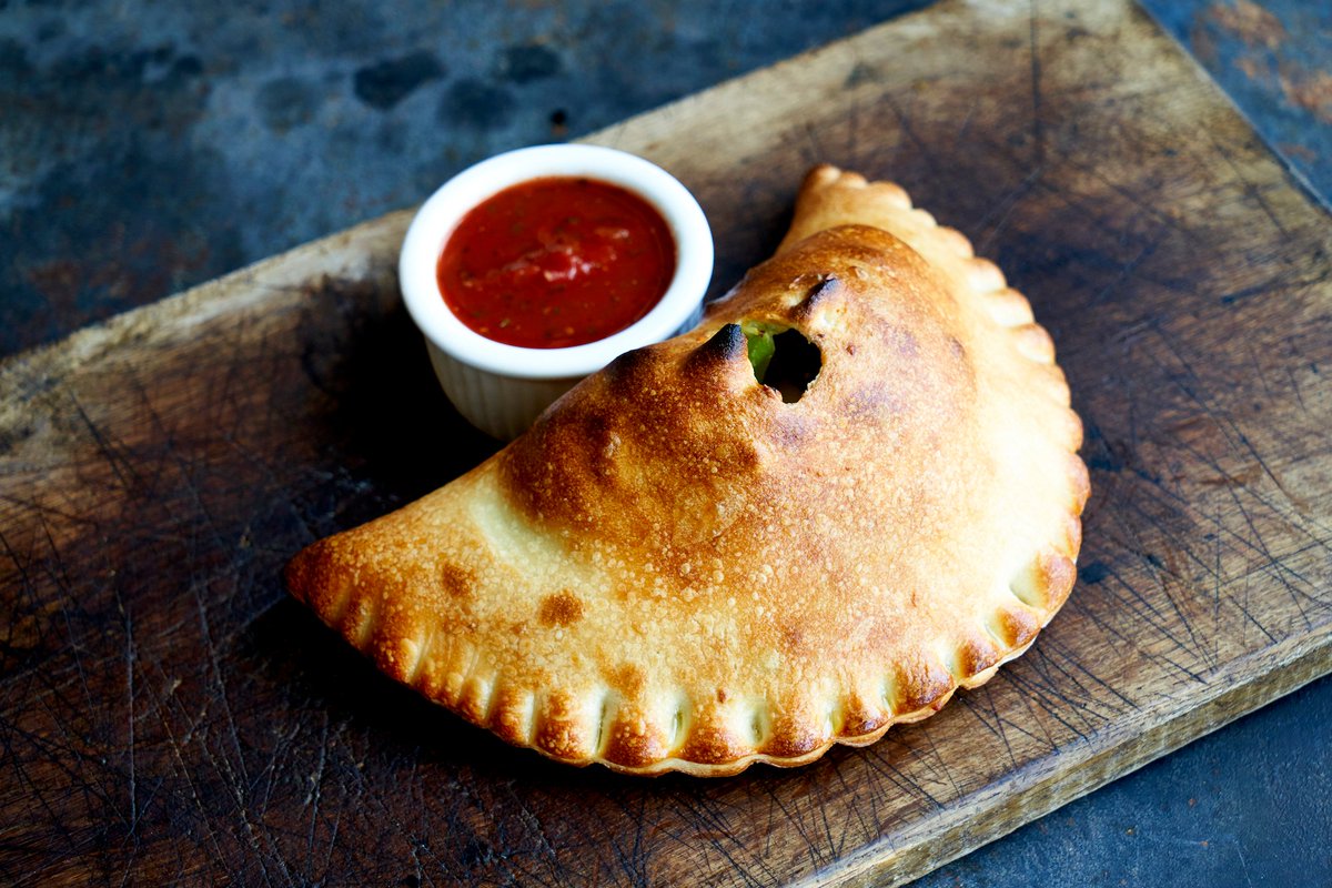 pagliaccipizza's tweet photo. It's getting colder and our Calzones are looking gooooood... Did you know you can customize your Calzone? Pick whatever cheese, veggies, and/or meat you'd like and we'll bake it up for you! 🥟

#pagliaccipizza #seasonofthecalzone #yummm #calzonezone #theoriginalhotpocket https://t.co/6U9E6f7zAt