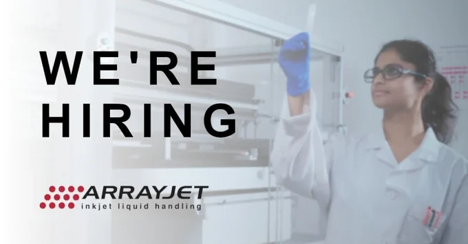 We are hiring. The scientist holds up a slide for QC inspection.
