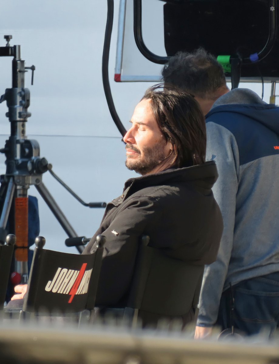bestofkeanu's tweet photo. keanu reeves basking in the sun on the set of john wick chapter 4 in paris (october 27, 2021) https://t.co/GUenfxNBZp