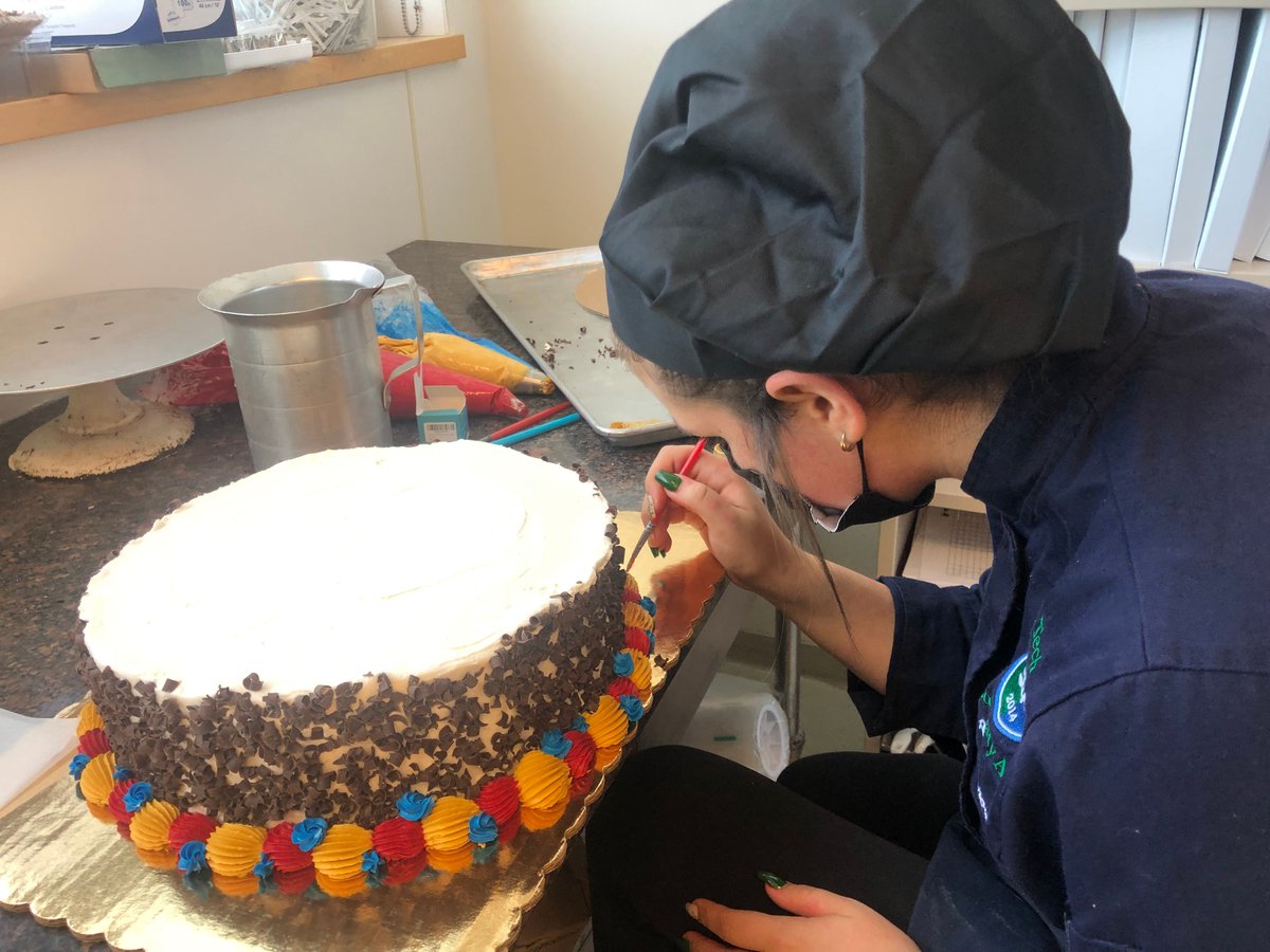 EssexNorthShore's tweet photo. Happy Birthday to the United States Marine Corps! We were proud to help with the Marine Corps Birthday Ball earlier this month! Angelena from Gloucester decorating the cake. #ENSCulinary #CareerTechEd #HawkTalk #CreateEncouragePromoteDevelop #ENSATS https://t.co/PtLHZZnKcY