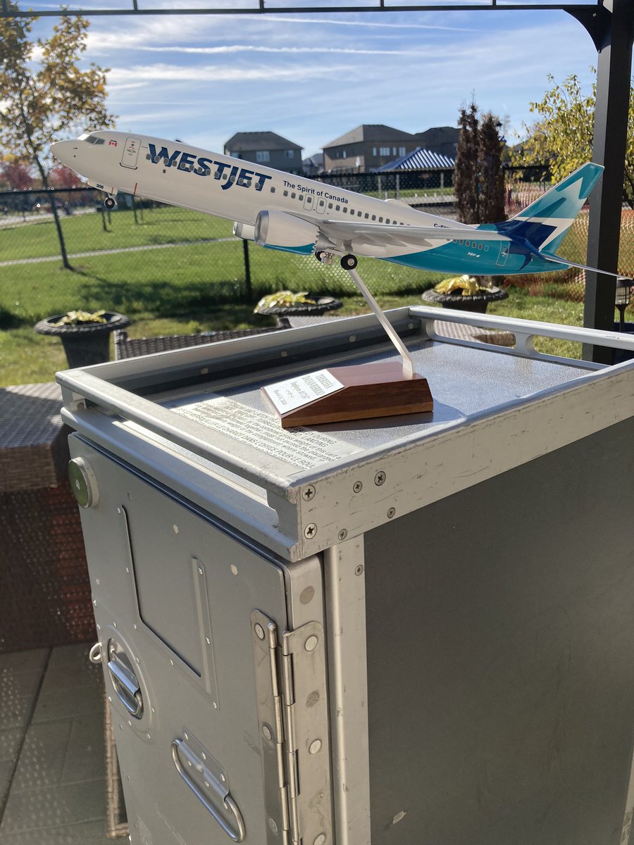 Tishaplus5's tweet photo. My retirement gift from @WestJet arrived today! Too bad it couldn’t come with all the amazing WestJetters that I shared time with too. Of course had to take a pic of my new plane on my souvenir galley cart. ✈️💙 #PlaneCollection #NeedABiggerDesk #TealFamily https://t.co/MQFaiUjFfa