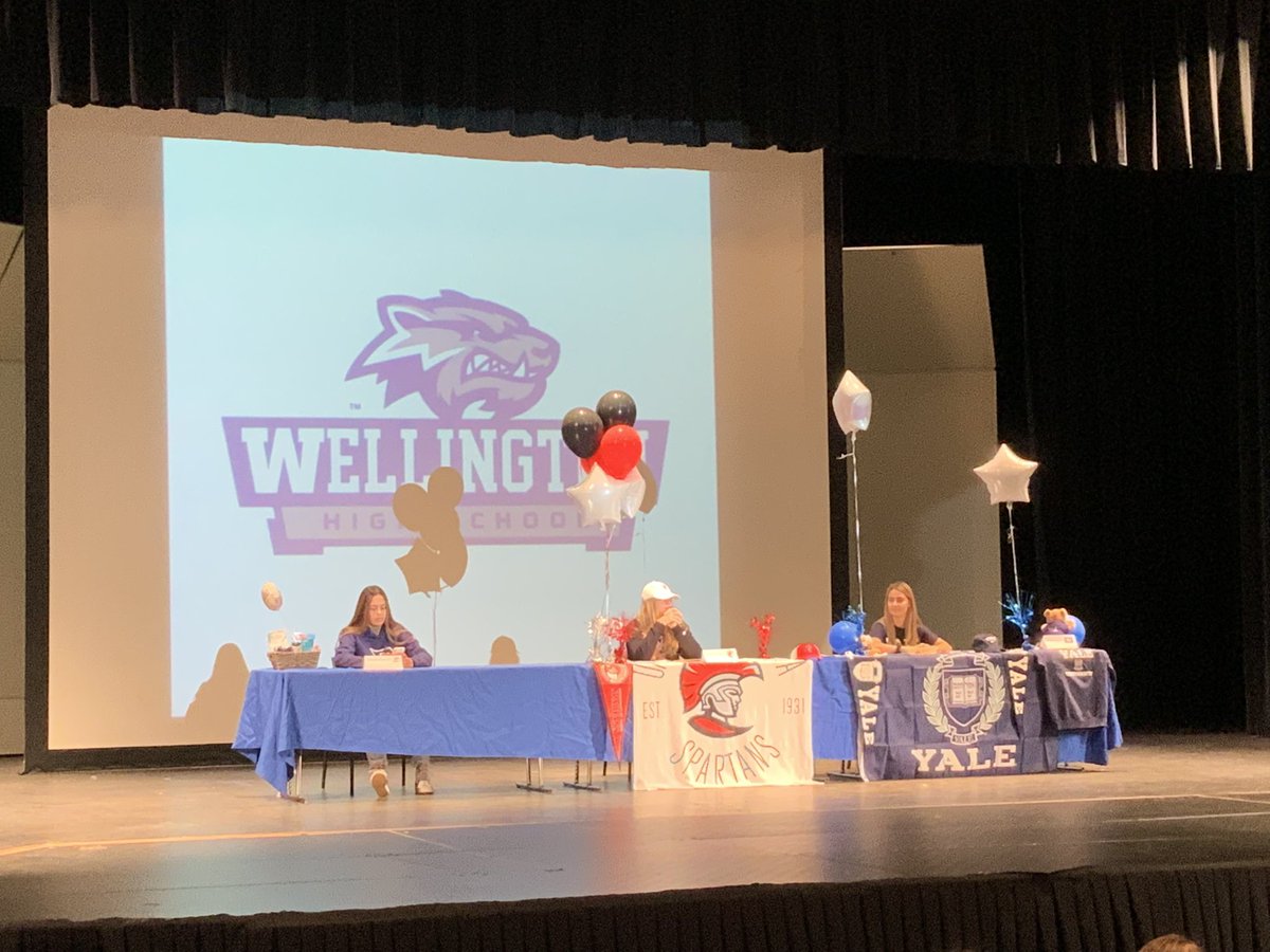 WellingtonHSFL's tweet photo. We are thrilled to share photos from today’s #NationalSigningDay event.  Three @WHS_athletics1 student-athletes signed letters of intent to continue their careers at the collegiate level.  #WHSLIVE @PrincipalHayden @pbcsd @Tampa_Softball @GoBigBlueSoccer @YaleTF_XC https://t.co/a7l75yl4iV
