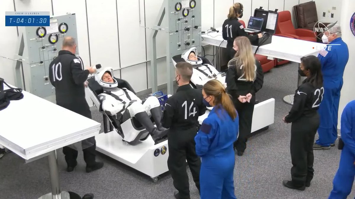 esaspaceflight's tweet photo. #Crew3 is suiting up. @astro_matthias on the left, @astro_kayla on the right. The seats they're sitting in are just like those in the Crew Dragon Endurance so technicians can check pressurisation and communication are working well before the crew enter their spacecraft 👨‍🚀👩‍🚀 https://t.co/XB0jBkAwUb