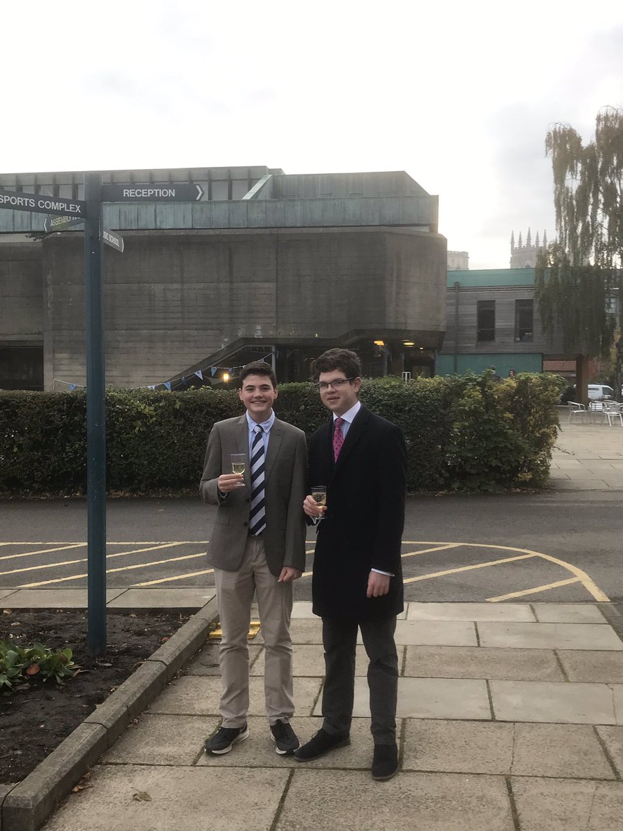 Two of Angie Wood’s tutees all dressed up to say happy birthday to her and celebrating with apple juice @BoothamSchool