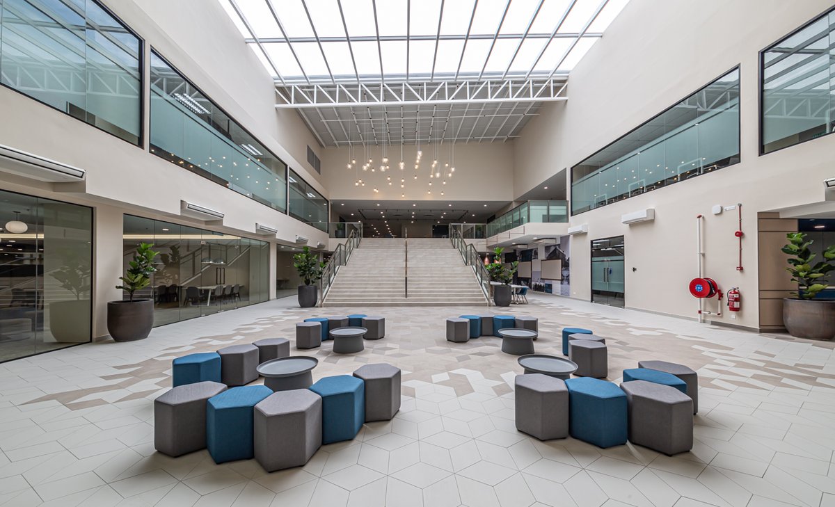 University of Southampton Malaysia campus main concourse with large staircase, blue and grey seats, and classrooms.