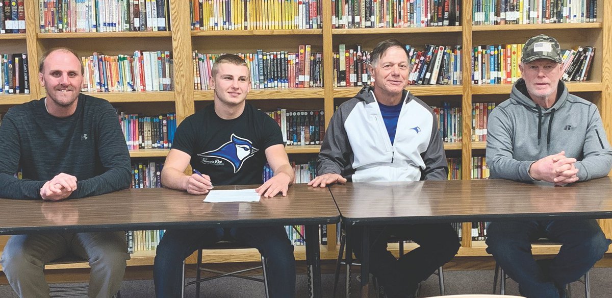 Zak Zimmermann signs his letter of intent to wrestle for MN West in worthington.