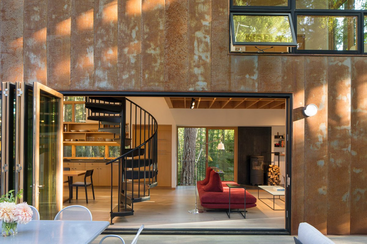 dezeen's tweet photo. Corten steel clads Little House/Big Shed in Washington by @DVDVNGLN: https://t.co/LLe9e41rLv https://t.co/OtxU3ihnyv
