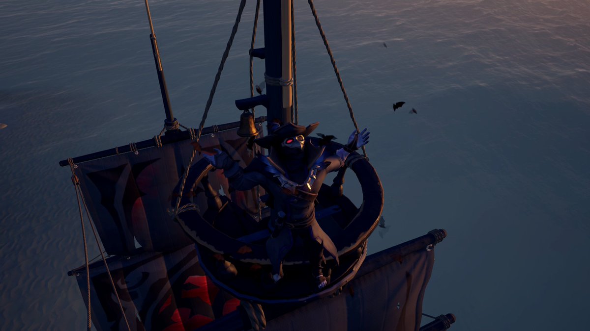 The pirate Cussin' Russel dressed in the Crimson Crypt costume standing in the crow's nest of the Dreadfully Evil while swarmed with bats.