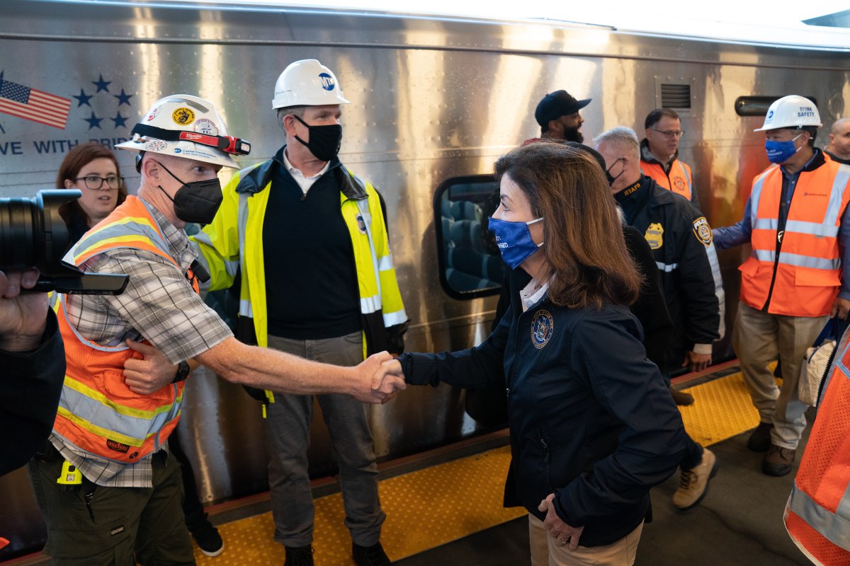 Governor Hochul shakes hands with individual on train platform