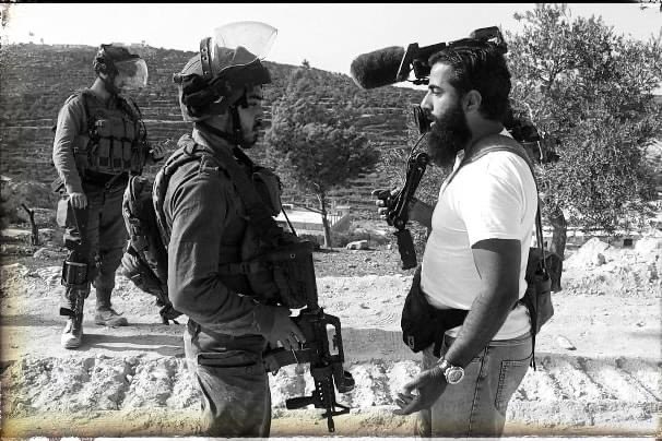 The weapon versus the camera. Beita, Palestine.