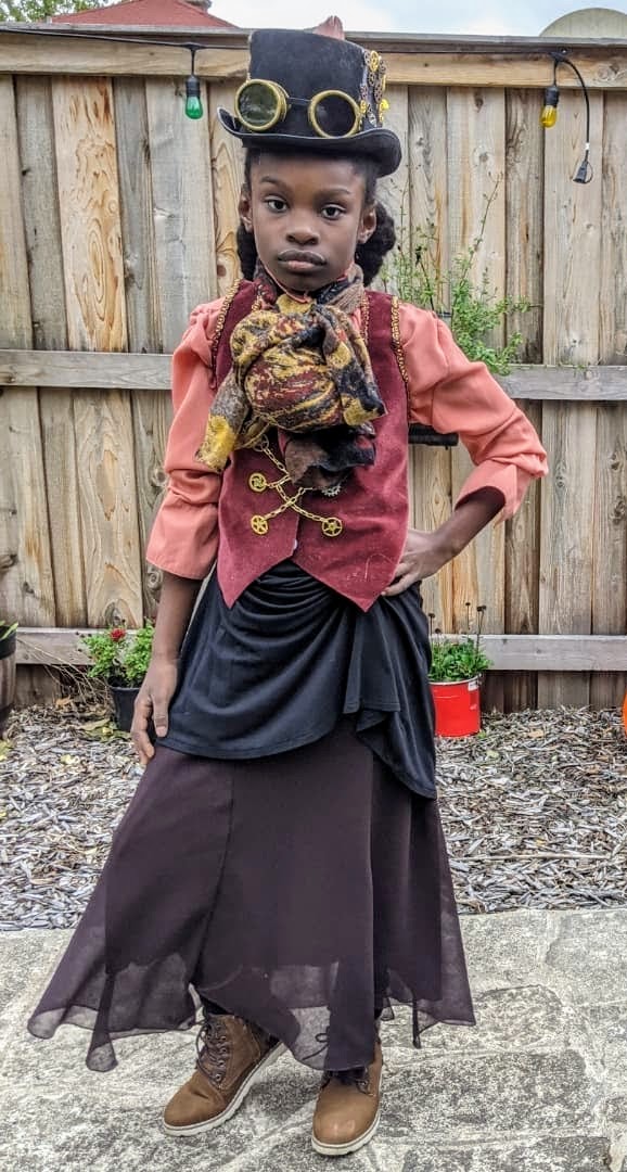 Black girl dressed in steampunk costume.