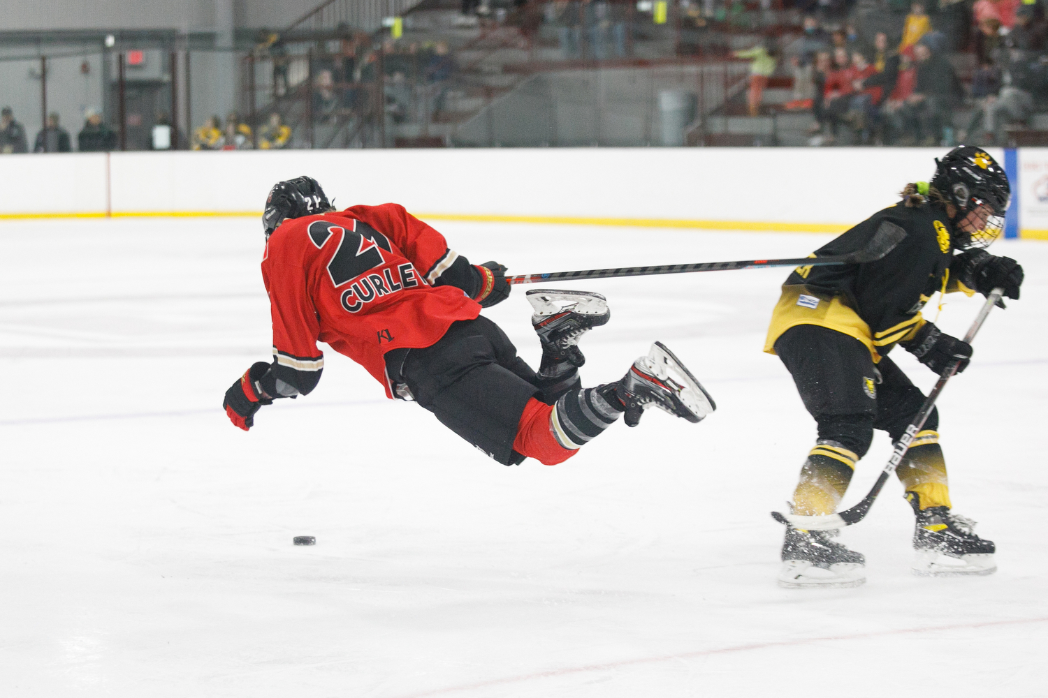 Amanda Boulier sends Toronto's Amy Curlew crashing to the ice on a tripping penalty