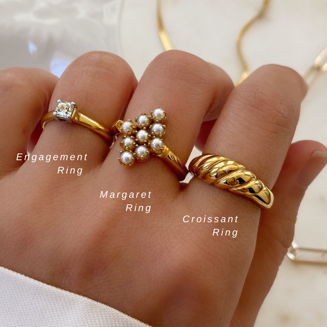 AUREVOIRLF's tweet photo. Perfect for stacking 🥐 Add some buttery luxe to your stack by pairing the Croissant Ring with heritage gold rings. Plated in a warm 18k gold, it creates a beautiful timeless look✨ 

Want to win $75 to spend at #aurevoirlesfilles? 🥰
Comment below which of these rings is yo https://t.co/ZwqW4yjBTK