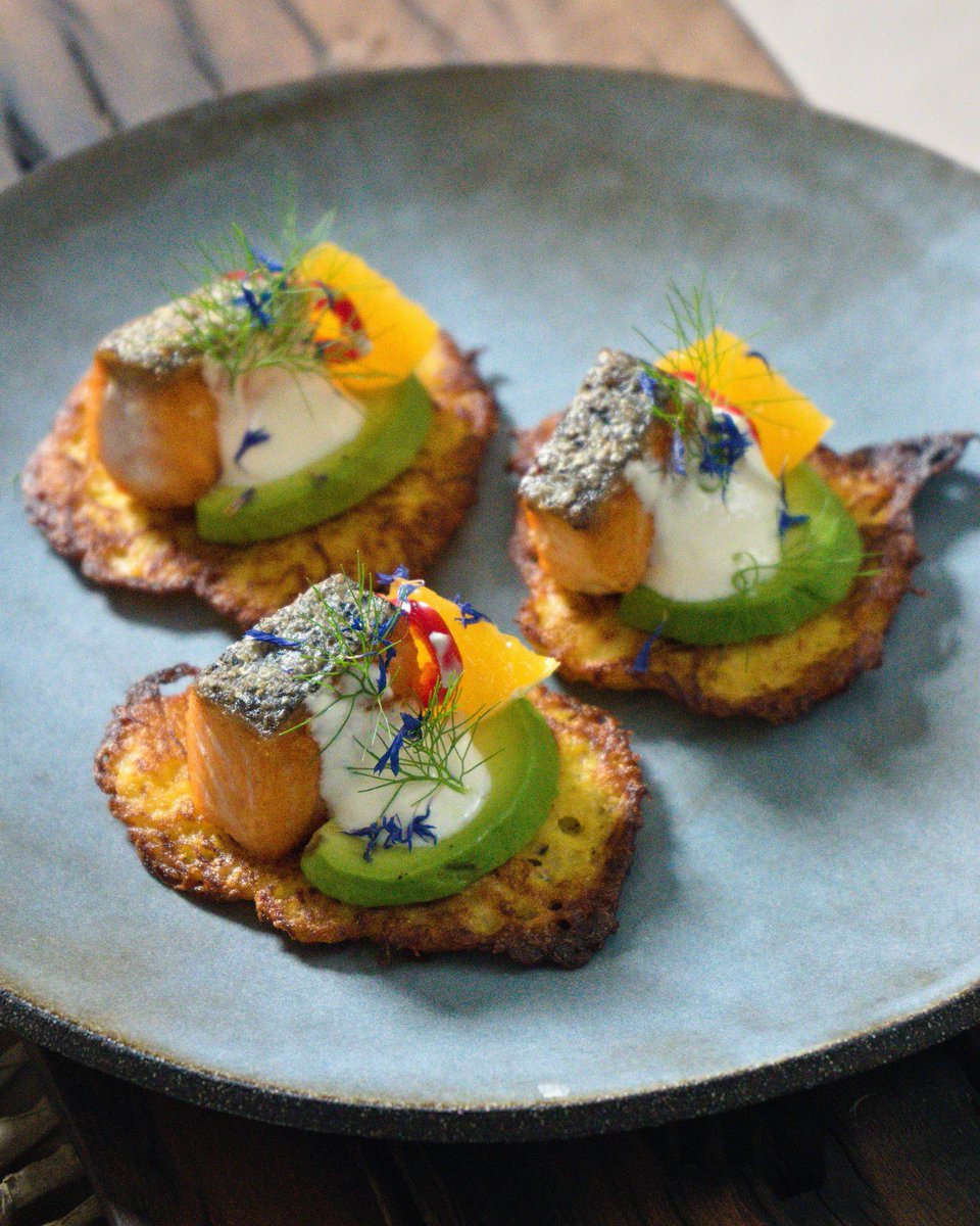 Crispy spaghetti squash #fritters with #avocado, crispy #salmon, #sweet red pepper and orange. Sour cream, then garnished with #fennel and blue cornflowers! A sweet and deeply #umami starter, or bulk it out for a full #meal! #homecooking #delicious