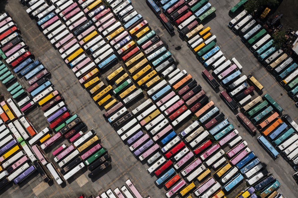 hkfp's tweet photo. Aerial shots show tour buses stored in a parking lot in Hong Kong on Monday, as strict Covid-19 measures keep tourists away from the city impacting the tourism sector. Photo: Isaac Lawrence/AFP. https://t.co/nknVpoYDeo