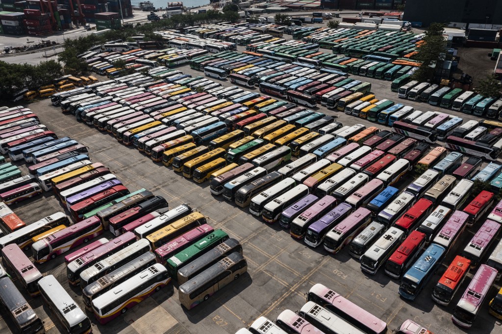 hkfp's tweet photo. Aerial shots show tour buses stored in a parking lot in Hong Kong on Monday, as strict Covid-19 measures keep tourists away from the city impacting the tourism sector. Photo: Isaac Lawrence/AFP. https://t.co/nknVpoYDeo