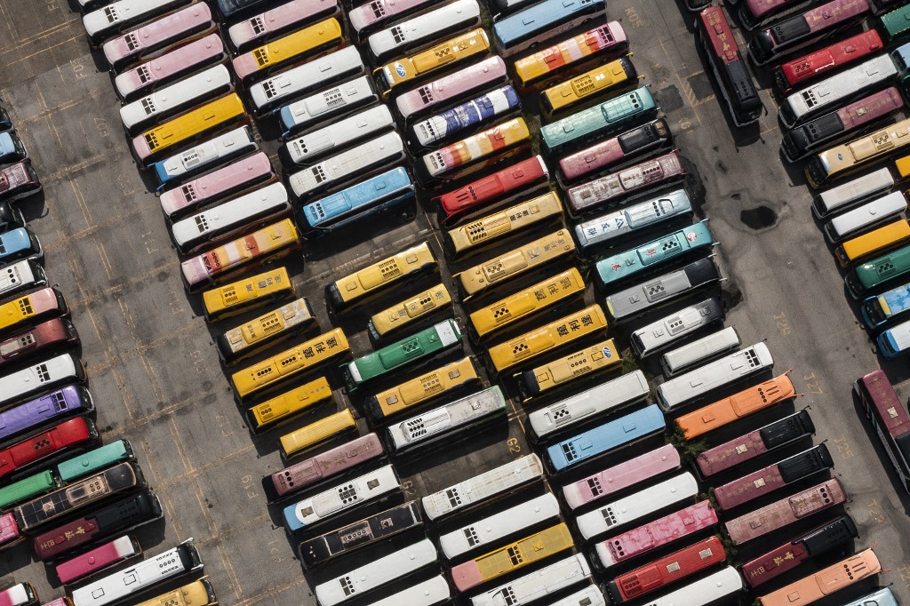 hkfp's tweet photo. Aerial shots show tour buses stored in a parking lot in Hong Kong on Monday, as strict Covid-19 measures keep tourists away from the city impacting the tourism sector. Photo: Isaac Lawrence/AFP. https://t.co/nknVpoYDeo