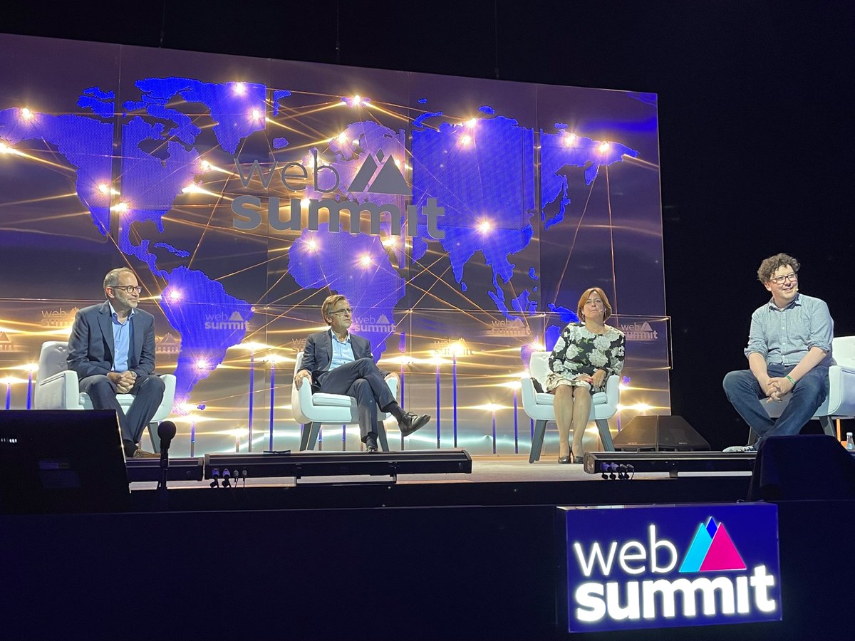 View of the Web Summit stage with the three panellists and chair. From left to right: Brian Carovillano – Associated Press, Matthew Kaminski – Politico, Dame Melanie Dawes – Ofcom, and the chair, James Ball – Bureau for Investigative Journalism.