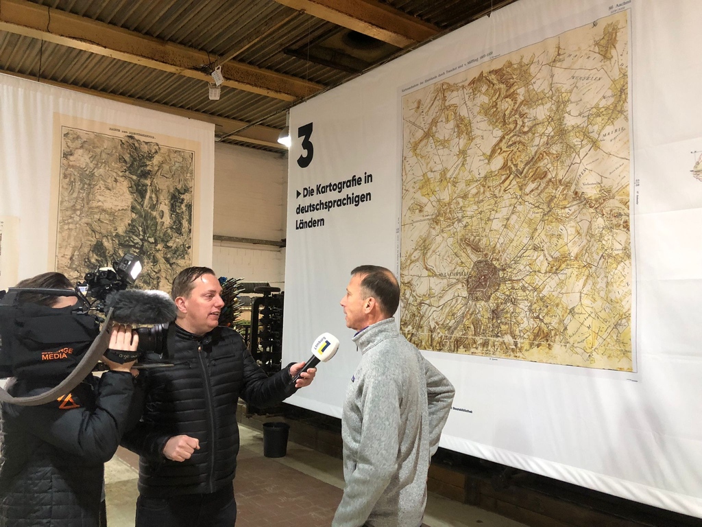 DMFF_eu's tweet photo. The Mapping the Mountains exhibition officially opened at 5:00 PM and tv station L1 was there. The fascinating exhibition on mountain cartography can be seen in Aachen until 30 November this year. Are you going to take a look?

#DMFF #Mappingthemountains #expositie #Aachen https://t.co/undsR0wDQZ