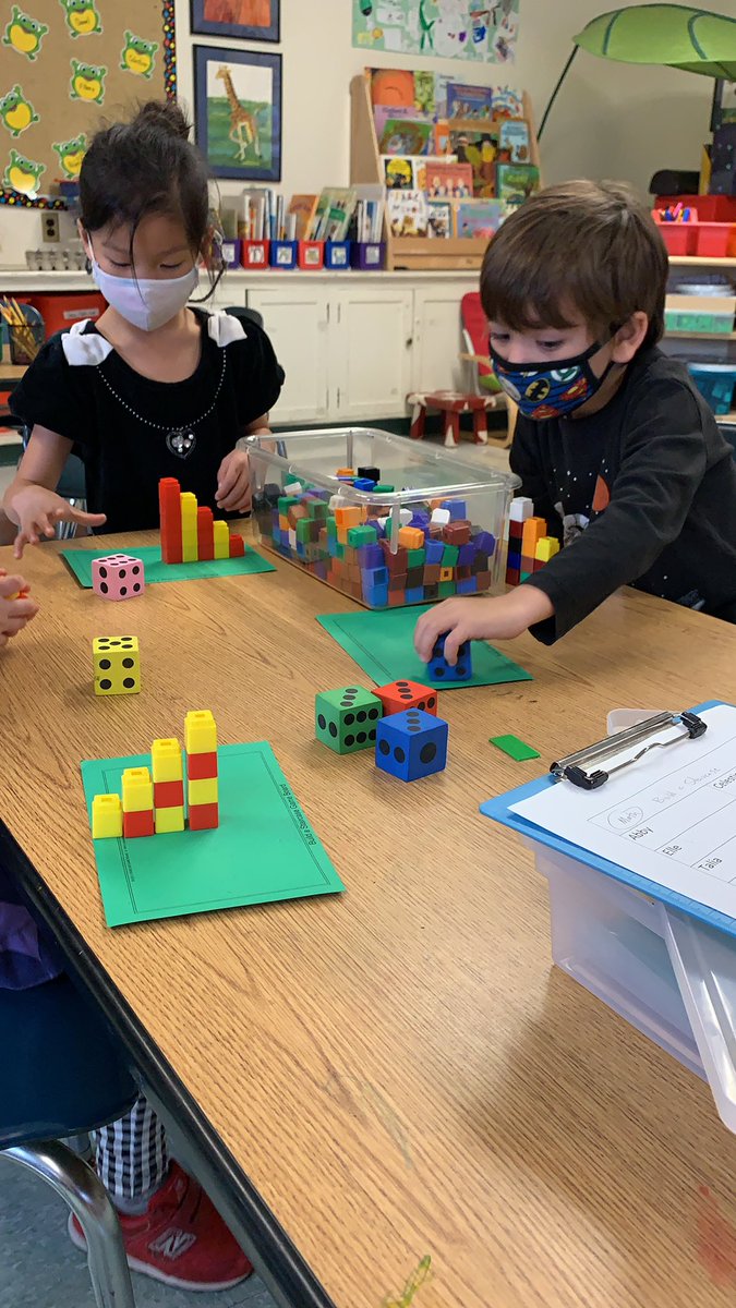 Kicking off some new center jobs this week. Observing and wondering about our hands, creating Diva lamps for the festival of Divali, and rolling , counting and building a staircase using cubes