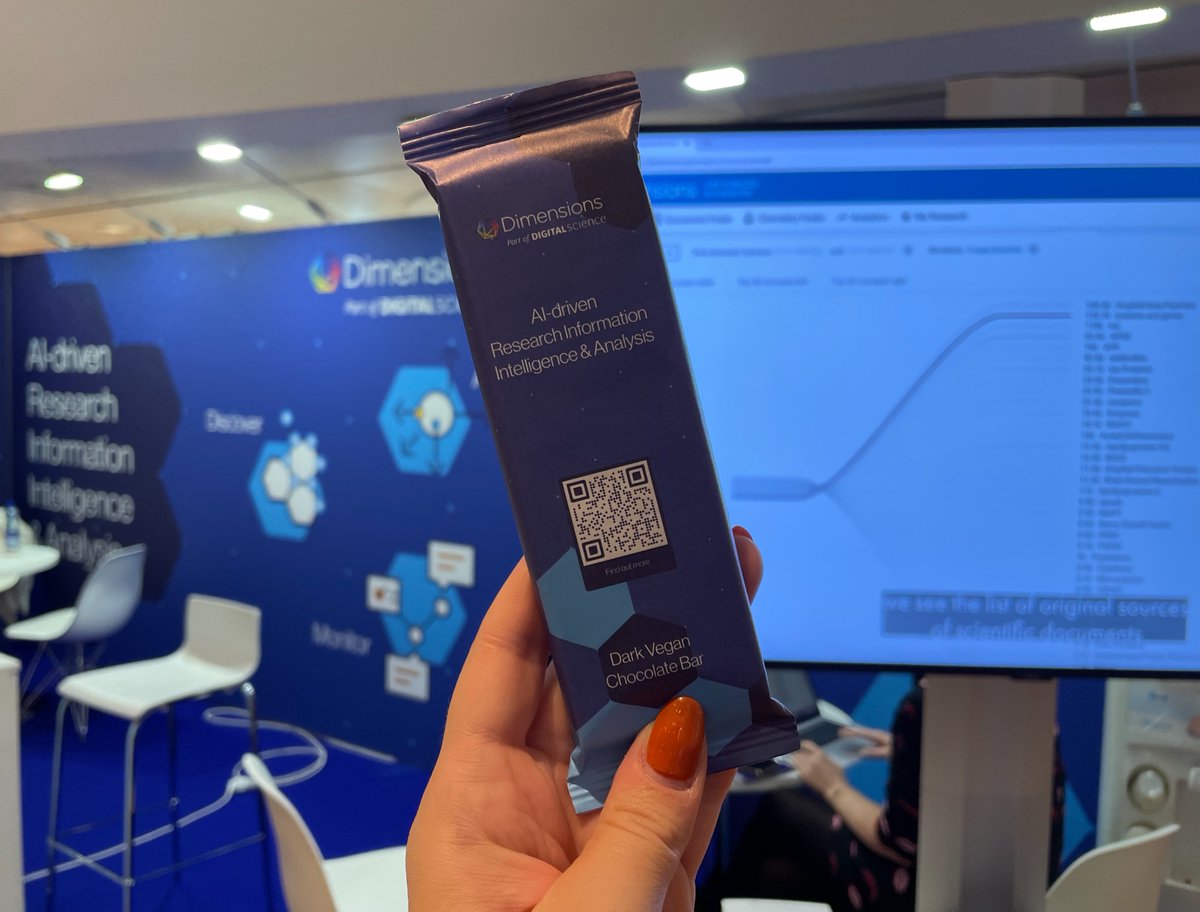 dimensions branded chocolate bar in front of the digital science booth at biodata world congress 2021