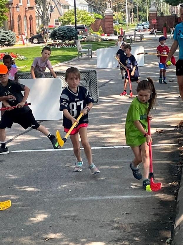 We pride ourselves on teaching kids how to play in their neighborhoods.  Use what you have (notice the tables as goals and the tennis ball as "puck") - and be creative in where you play.  These small-side games could happen on driveways or sidewalks!  Get out there and play!!