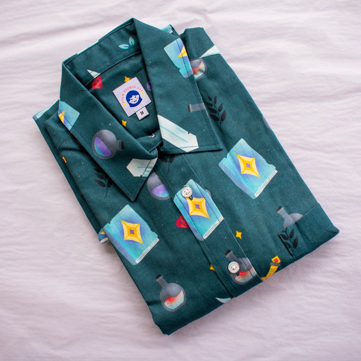 fromstudiokay's tweet photo. ✨GIVEAWAY✨

last giveaway is this magical new RPG button-up shirt! it's made from cotton-linen fabric with sizes from 3XS to 8XL. 

(u can also grab one from my store right now too!💖)

⚔️follow @fromstudiokay
💎 like + retweet this post 
🌿 1 tag = 1 entry

ends 11th nov! https://t.co/ORDQBz3Wx9