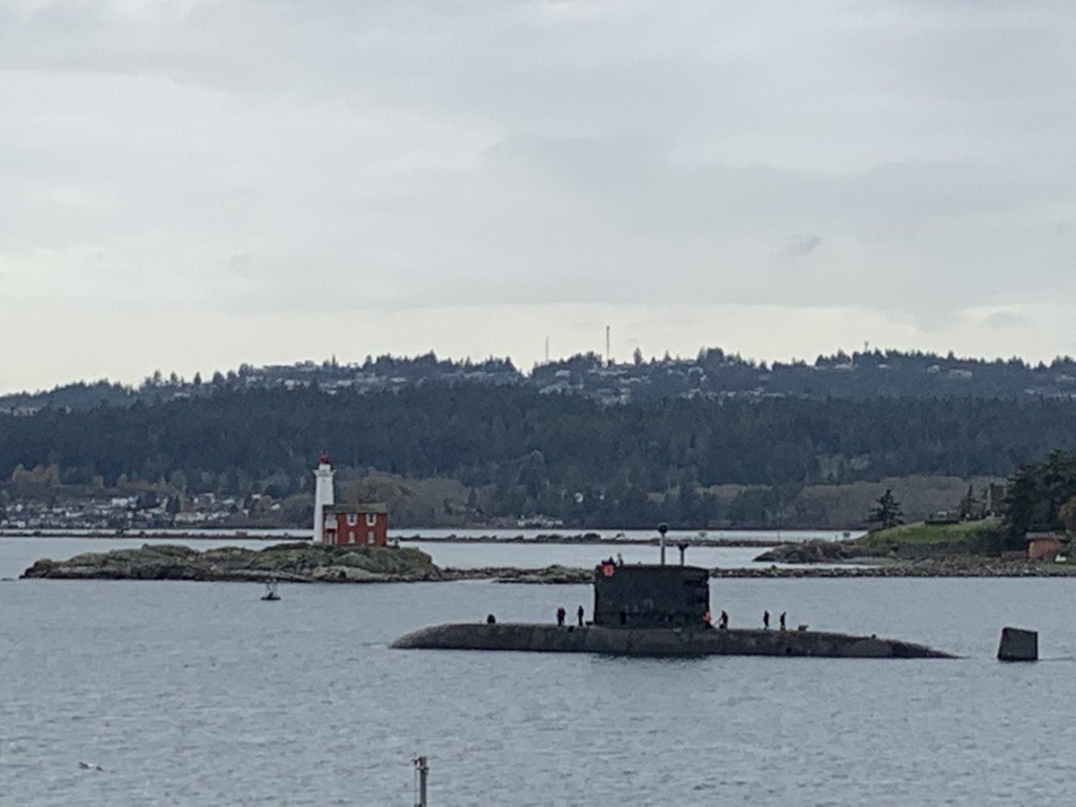 AngusTopshee's tweet photo. Adorned with a poppy #HMCSVictoria passes #BickfordTower and @FortRoddFisgard to head to sea for local force generation (training and trials)

#CanadaRemembers https://t.co/QSiz3eSpgy