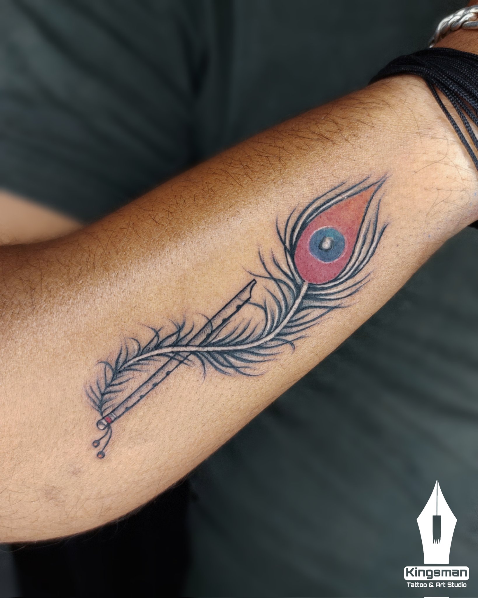 flute tattoo with peacock feather tattoo done at xpose tattoos jaipur