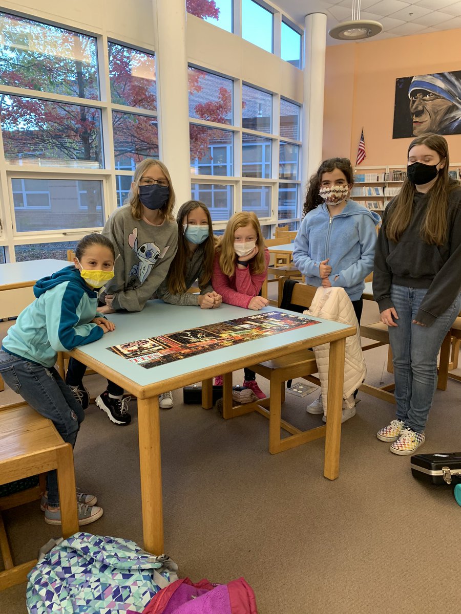 NAMSLibrary's tweet photo. Finished! The morning puzzle people showing off their latest puzzle! Teamwork! @NAMiddle #librarypuzzles https://t.co/9f32XaEeSx