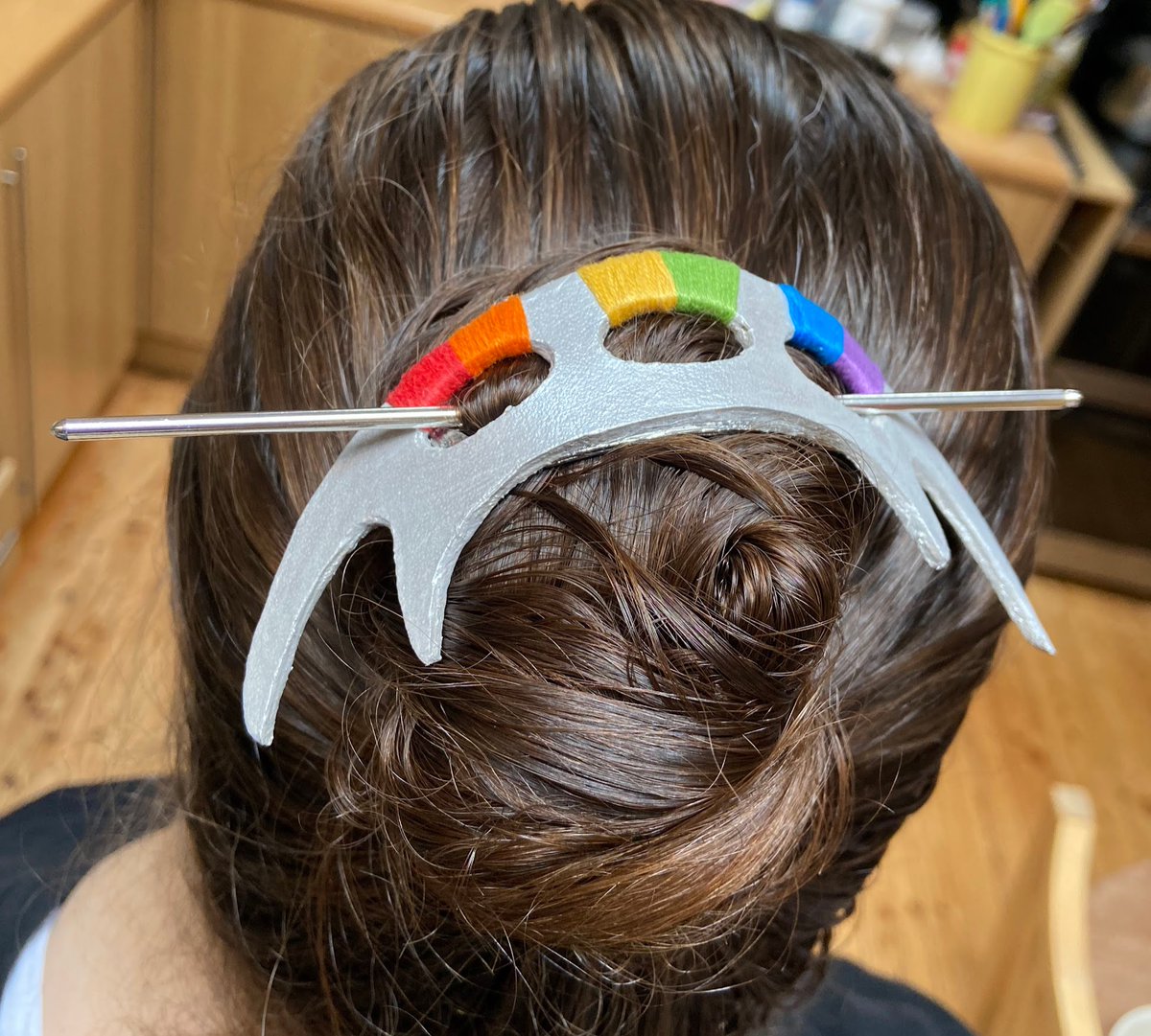 WriterCrafter's tweet photo. I made a rainbow bat'leth hair accessory! Scrap leather, @AngelusBrand silver leather paint, @dmccreativewrld floss. Made a template from bat'leth image, cut with craft knife. E6000 glued it together. @StarTrek #StarTrek #Klingon #PrideTrek #crafts https://t.co/fnZSq2oJ1D