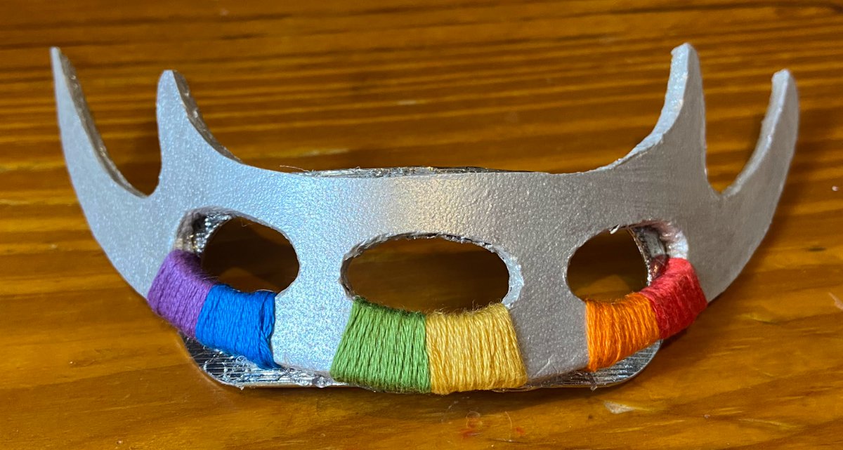 WriterCrafter's tweet photo. I made a rainbow bat'leth hair accessory! Scrap leather, @AngelusBrand silver leather paint, @dmccreativewrld floss. Made a template from bat'leth image, cut with craft knife. E6000 glued it together. @StarTrek #StarTrek #Klingon #PrideTrek #crafts https://t.co/fnZSq2oJ1D