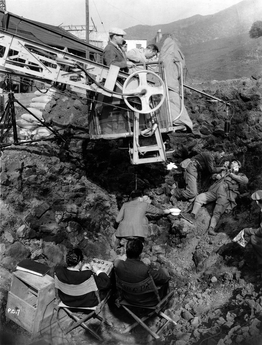 AmericanCine's tweet photo. #ACArchive: Aboard the famed 50' “Broadway” camera crane, Arthur Edeson, ASC (leaning over) checks his frame on costars Lew Ayres and Raymond Griffith while shooting the anti-war classic All Quiet on the Western Front (1930), directed by Lewis Milestone. https://t.co/wSmAaALbZV