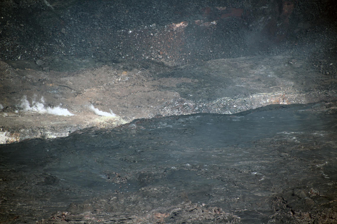 USGSVolcanoes's tweet photo. It’s happened. Lava has begun to creep out onto the down-dropped block in Halema‘uma‘u crater. Telephoto image shows lava, arrow on lake photo shows location (as does the map). No new hazard. All lava activity remains confined within the crater in Hawai‘i Volcanoes National Park. https://t.co/Jp3tvDmR59