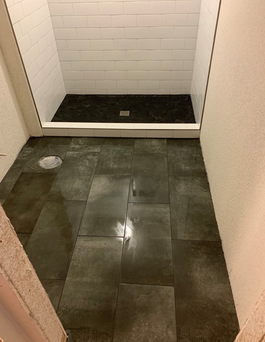 tiling_expert's tweet photo. Schluter shower pan with mosaic tiles on it. Subway tile in the shower surround with a niche on the back wall. Schluters on all open edges. Porcelain tile 12x24 on the bathroom floor in offset pattern.

#experttouchtiling #denvertiles #flooring #porcelaintiles https://t.co/mjNnJ5y7mT