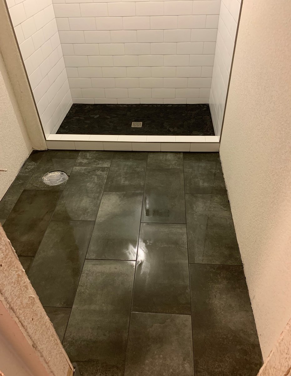 Schluter shower pan with mosaic tiles on it. Subway tile in the shower surround with a niche on the back wall. Schluters on all open edges. Porcelain tile 12x24 on the bathroom floor in offset pattern.

#experttouchtiling #denvertiles #flooring #porcelaintiles