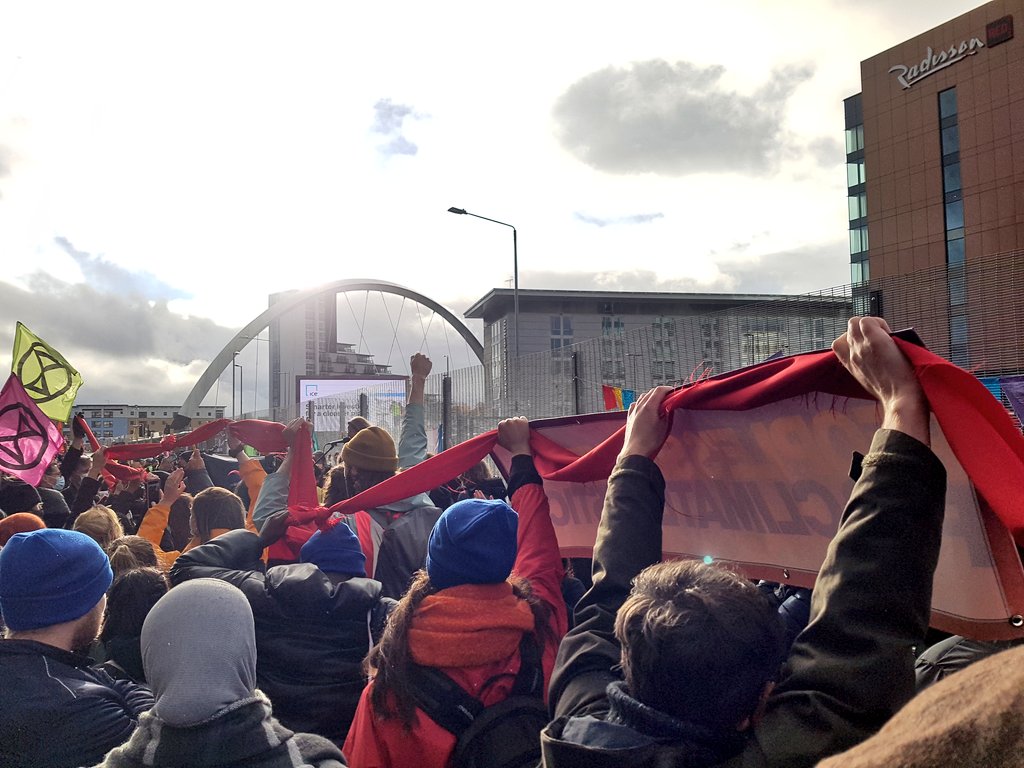 ScotClimateCamp's tweet photo. We're drawing a red line at #cop26: the failure of these talks will not stop our movement. Climate justice now! 
#RisingClyde #PollutersOut https://t.co/Vx3SBYkUk1
