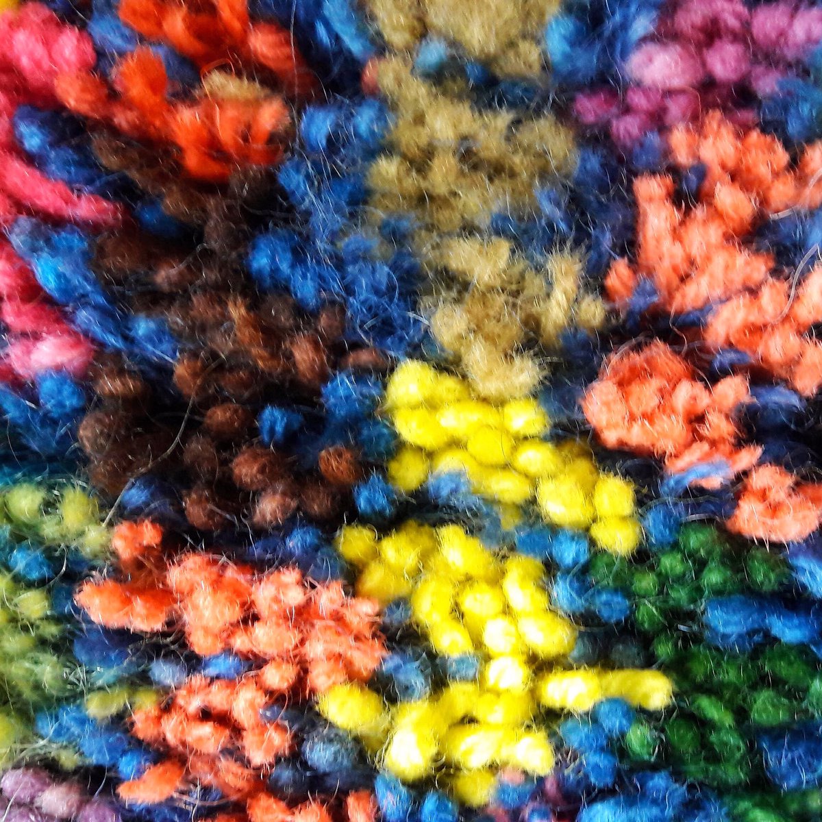 Latch hook rug made with British wool dyed with natural dyes. It is about an inch thick.