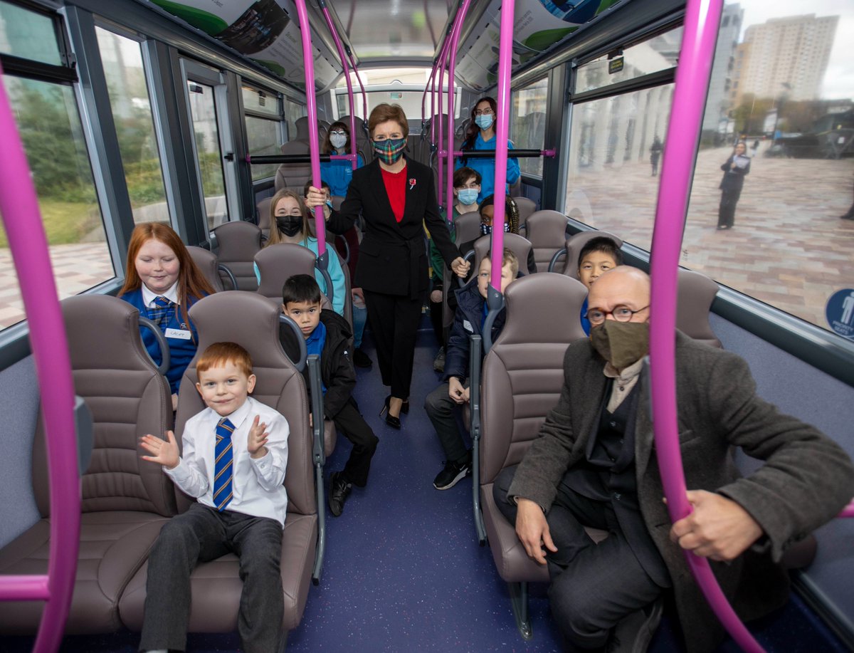 First Minister Nicola Sturgeon and Scottish Government Minister Patrick Harvie join school children to board an electric bus and celebrate free bus travel for Under 22s.